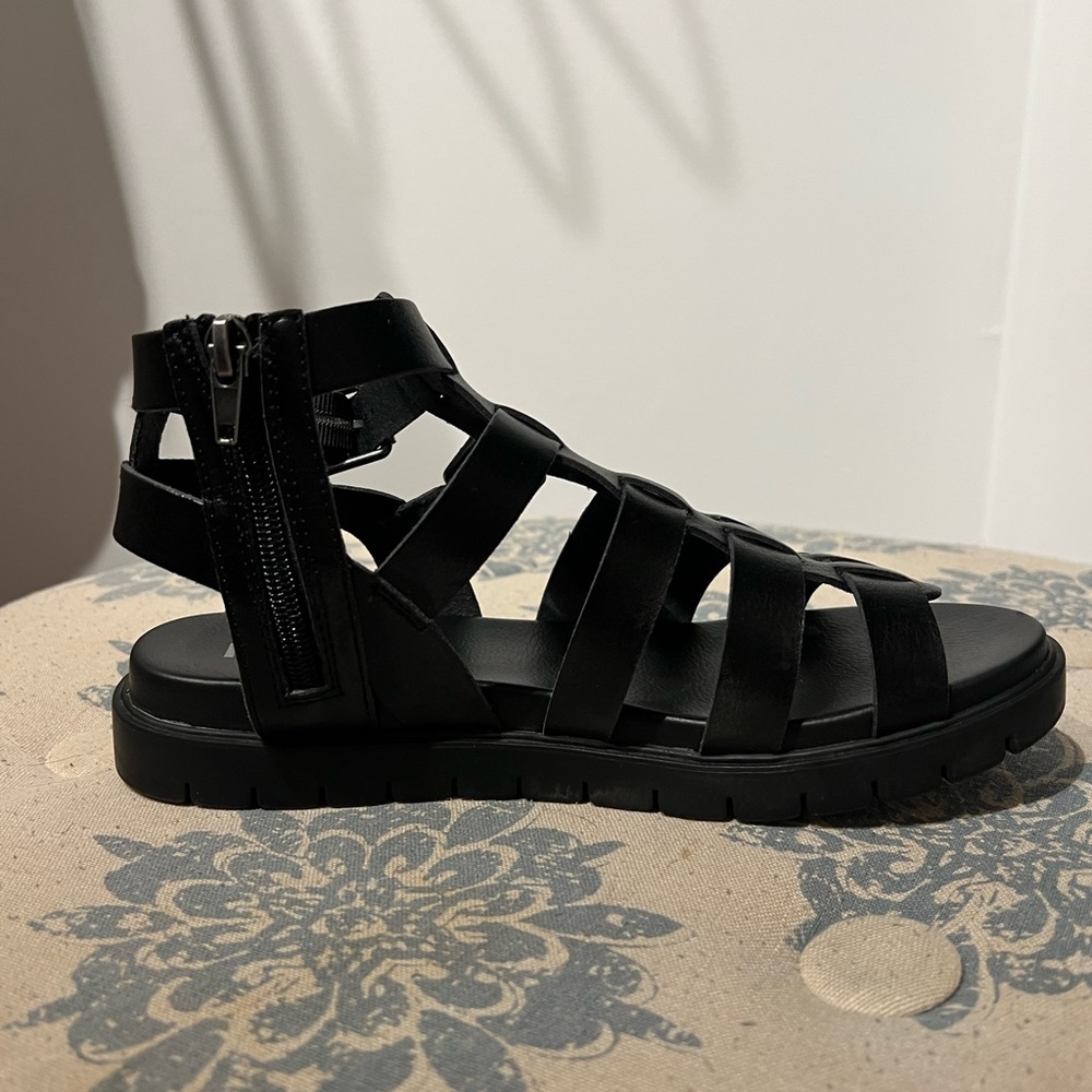 Black gladiator sandals.